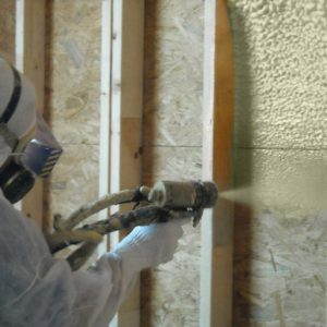 Spray Application of Lapolla 4G Spray Polyurethane Foam into wall cavity